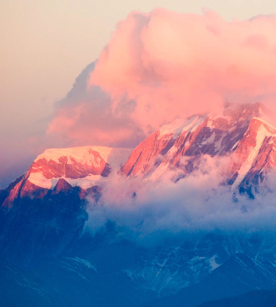 Snowcapped mountains with the sunrise